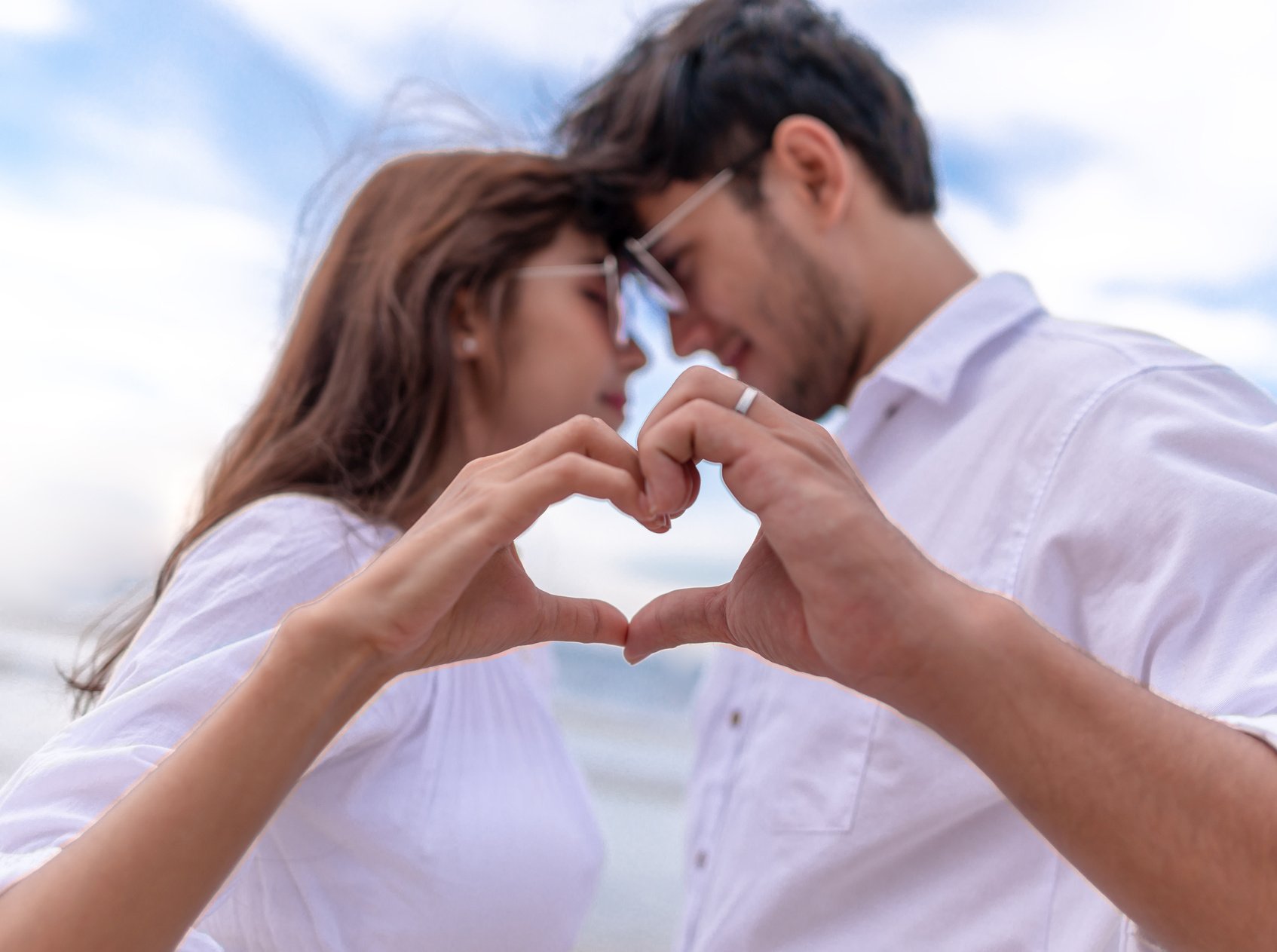 Couple Making Heart Shape with Hands